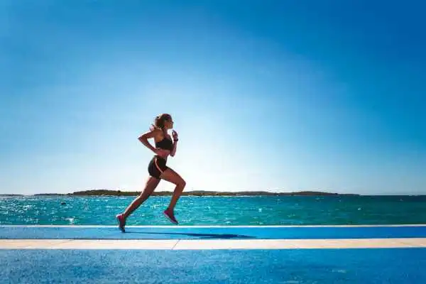 Woman running showing strong leg muscle Leeds